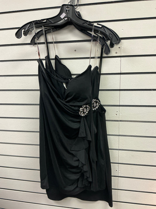 Elegant black dress with brooch on the side and ruffles